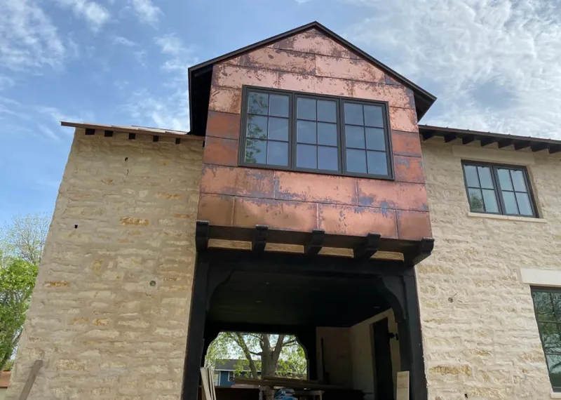 Copper metal panel facade on a stone building for Skylight Installation in Hobe Sound