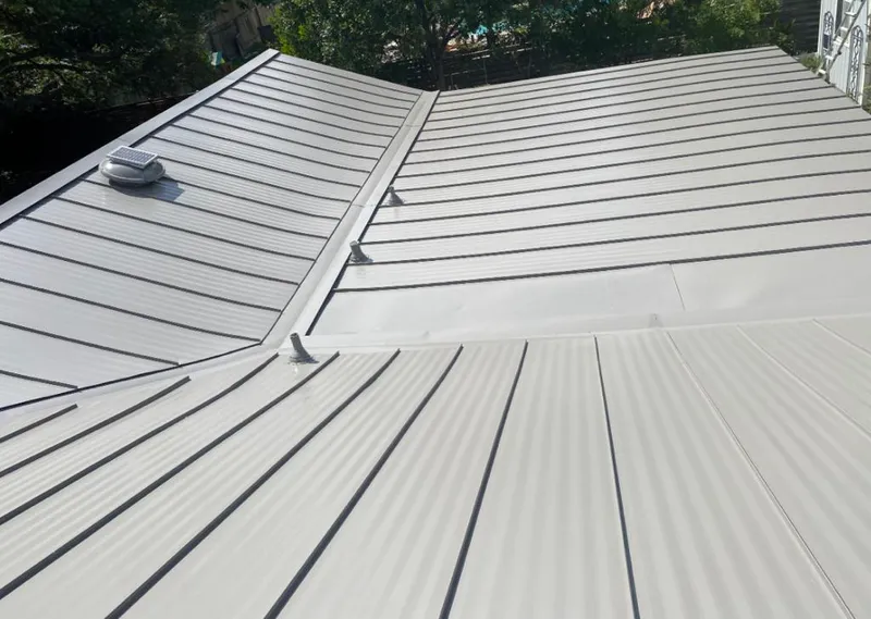 Solar attic fan installed on a metal roof for Roof Ventilation in Hobe Sound