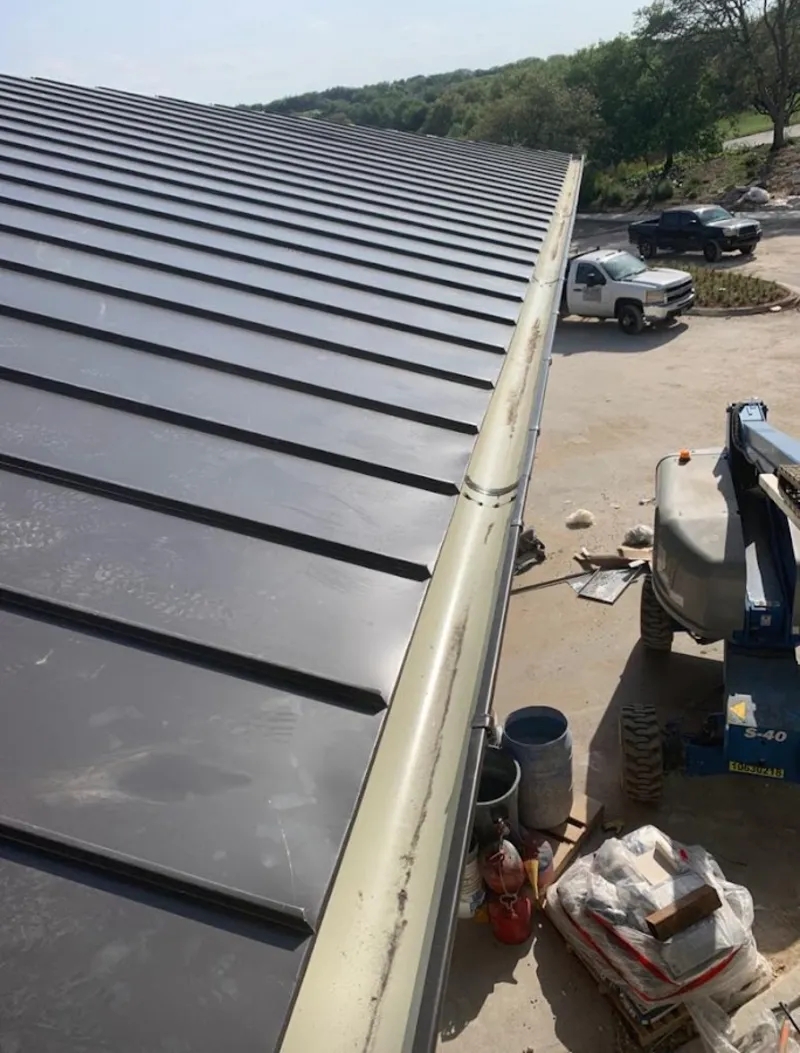 Standing seam panel and gutter detail on a metal roofing jobsite in Hobe Sound
